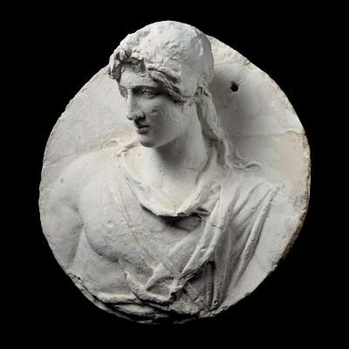 Circular plaster medallion for use as a model with a young man in Classical Greek style, found in a merchant's store room. 1st century A.D. Plaster.