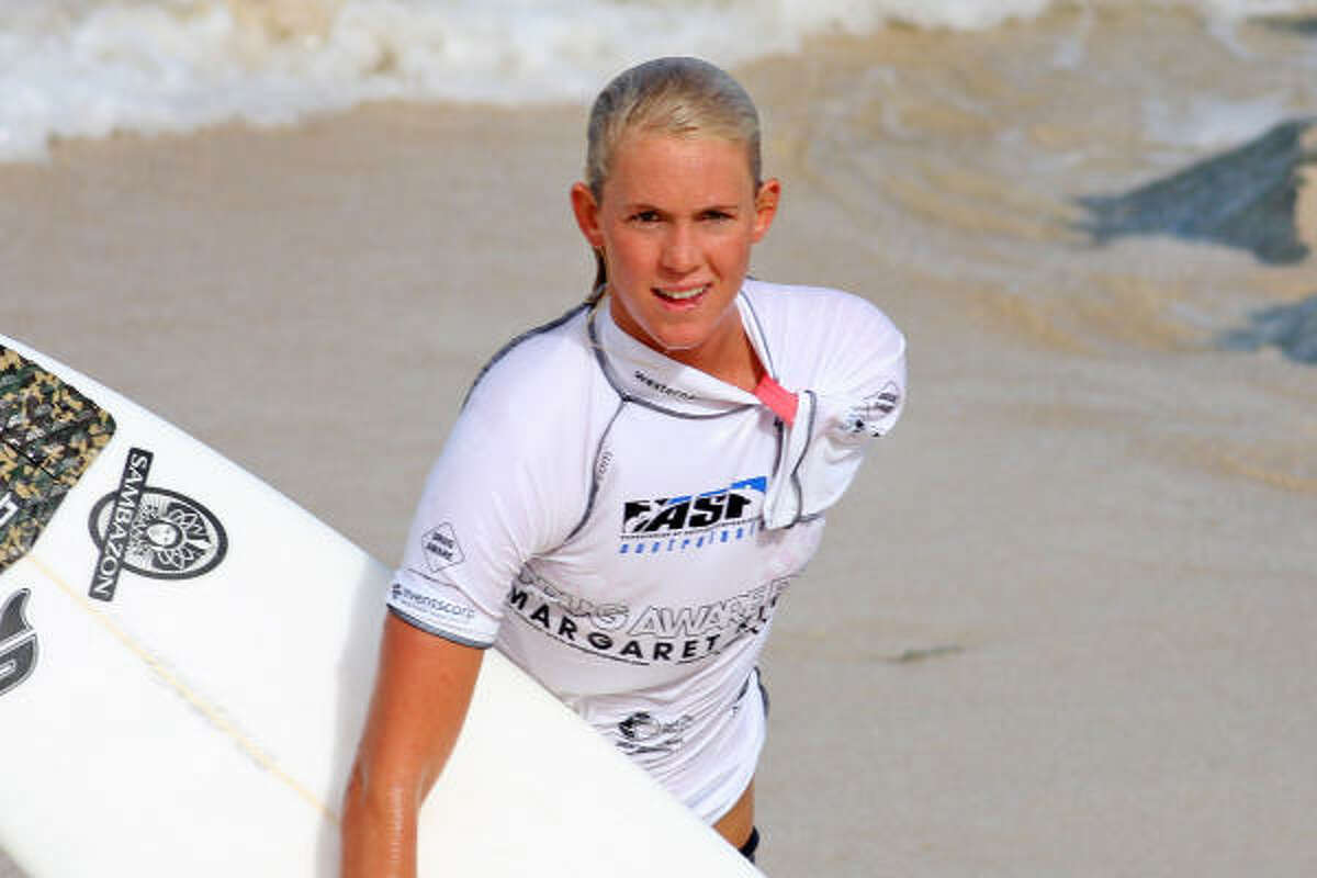 Woman taken to hospital with shark still attached to her arm