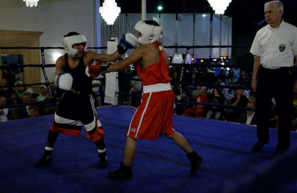 Richard Hernandez trades punches with Daniel Ybarra, right. Ybarra won the match, his fourth consecutive Golden Gloves win.