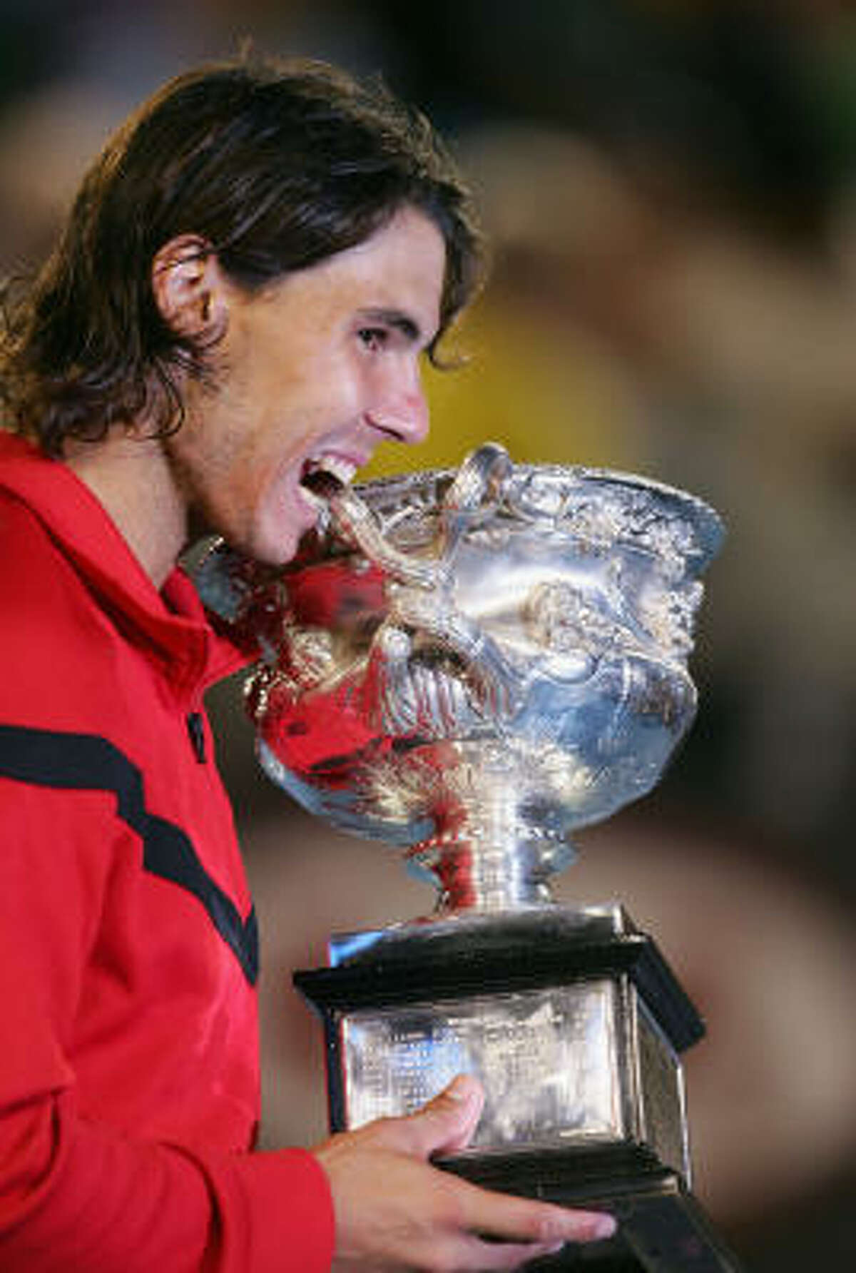 February 1, Rafael Nadal defeats Roger Federer in men's final Rafael Nadal poses with the Norman Brookes Challenge Cup after winning his men's final match against Roger Federer.