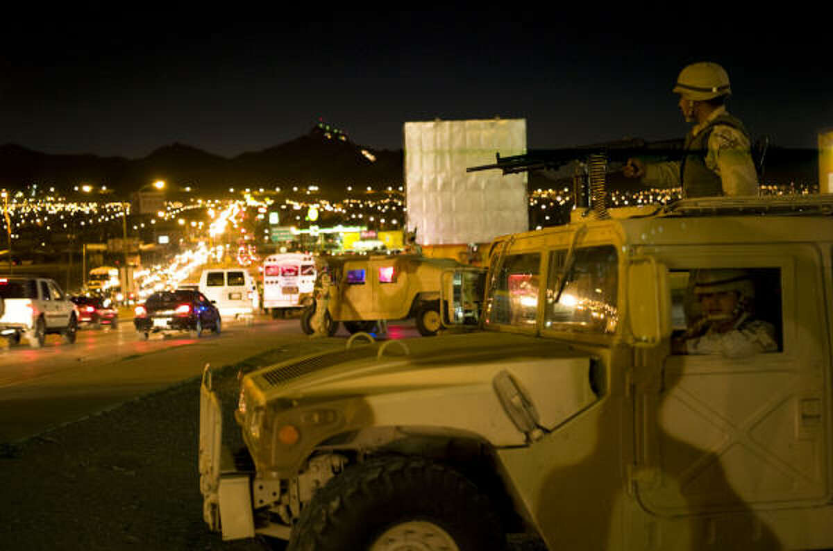 Mexican troops patrol after a recent shootout that killed three half a block from the international bridge leading to El Paso.