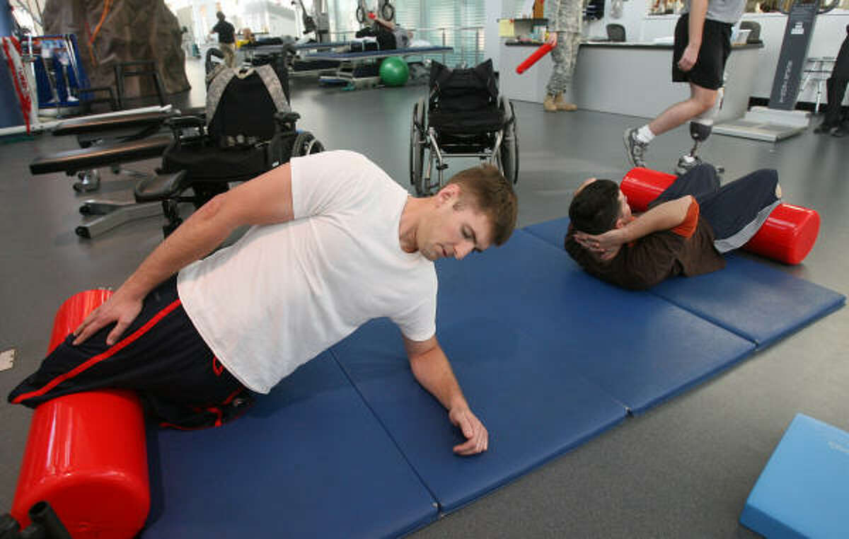 Cpl. Travis Dodson, a 23 year-old Marine who had his legs blown off by a grenade in Iraq's Anbar Province on Valentine's Day 2007, finishes his last set of push ups during his workout. Travis is racing in the Houston half-marathon Sunday.