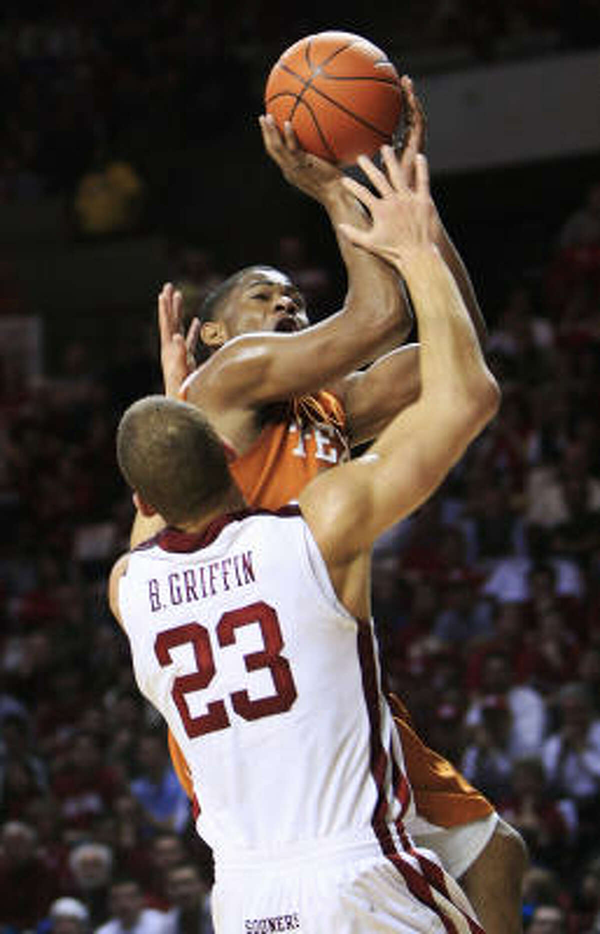 Texas guard Harrison Smith, rear, is called for an offensive foul as he runs into Oklahoma forward Blake Griffin on his way to the basket in the first half.