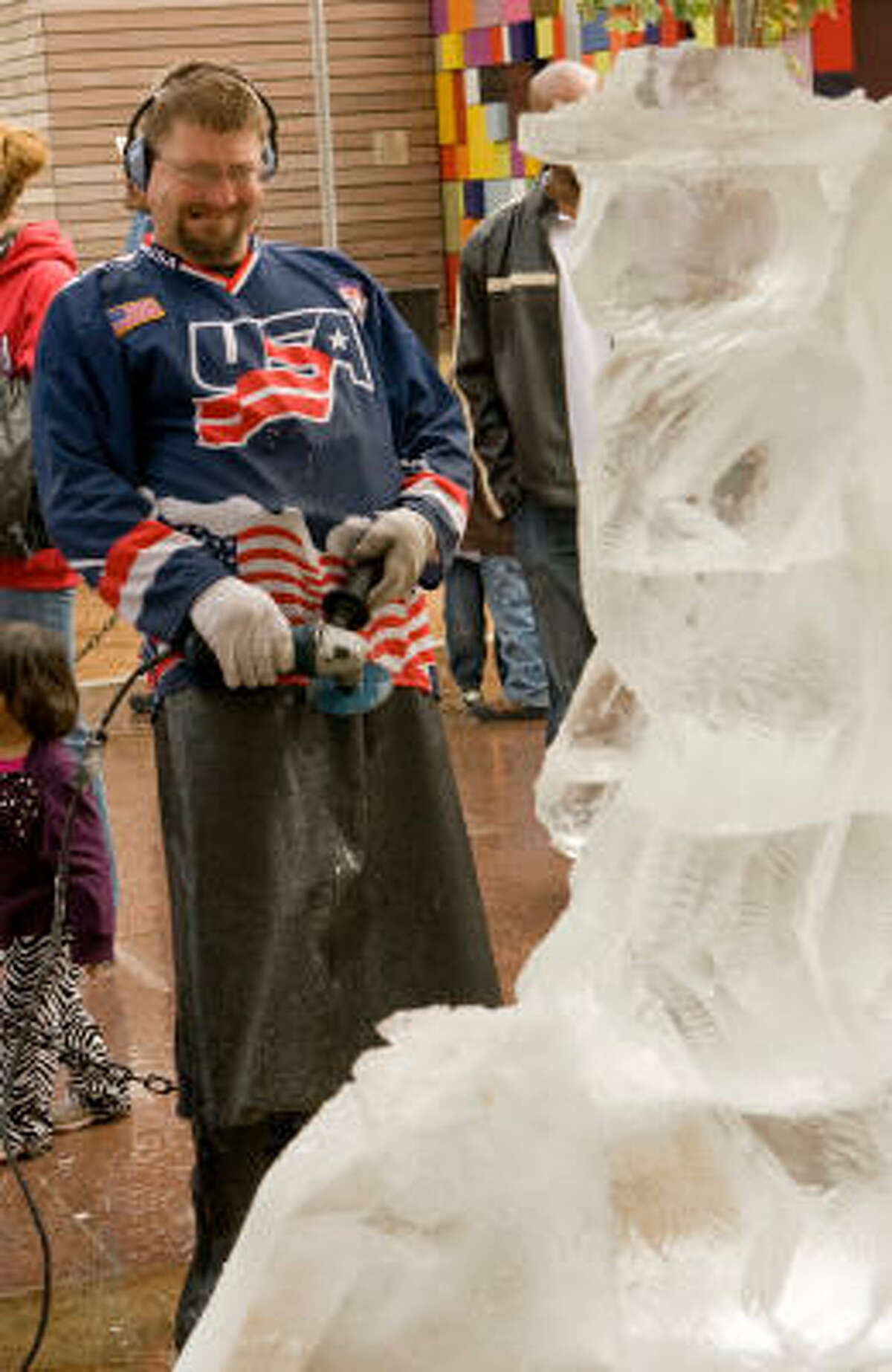 Dan "Hollywood" Rebholz of Chicago steps back to view his sculpture. The sculptors competed in an ice sculptor contest Saturday in downtown Houston.