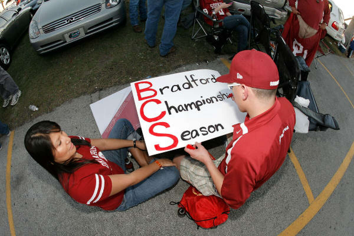 Jarrod Tahsequah, fan of the Oklahoma Sooners makes a sign in support of Oklahoma quarterback Sam Bradford prior to the FedEx BCS National Championship game.