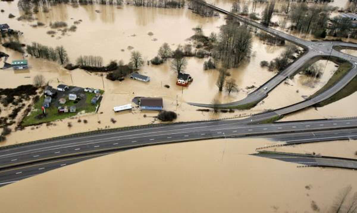 Interstate 5, at bottom, is partially covered by muddy flood water from the Chehalis River on Jan. 8, 2009, in Chehalis, Wash.