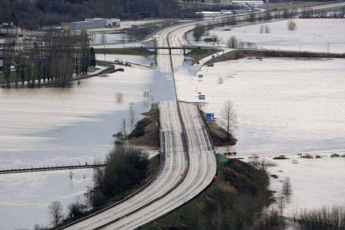 Interstate 5 is covered by the flooding Chehalis River Thursday morning in Chehalis, Wash.