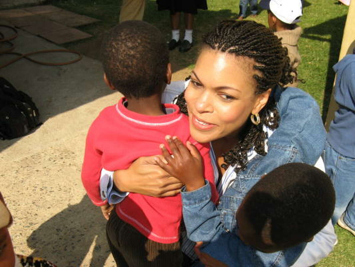 Wheeler Avenue Baptist church member Adria Tillman hugs a child at the Touch of Life nursery at the Baptist Church of Troyeville in Johannesburg.