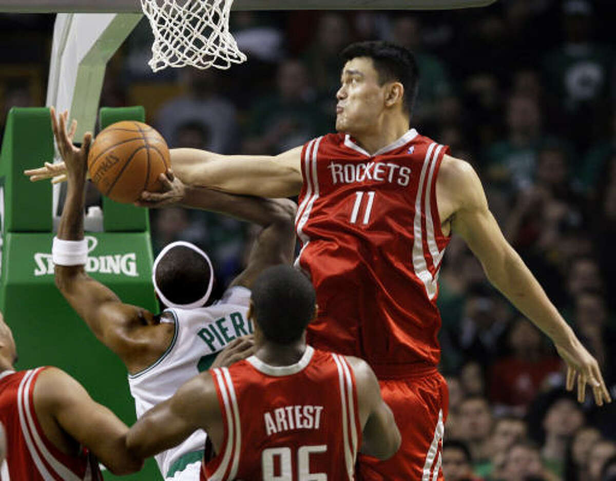 Yao Ming, center, blocks a shot by Celtics guard Paul Pierce in the second half.