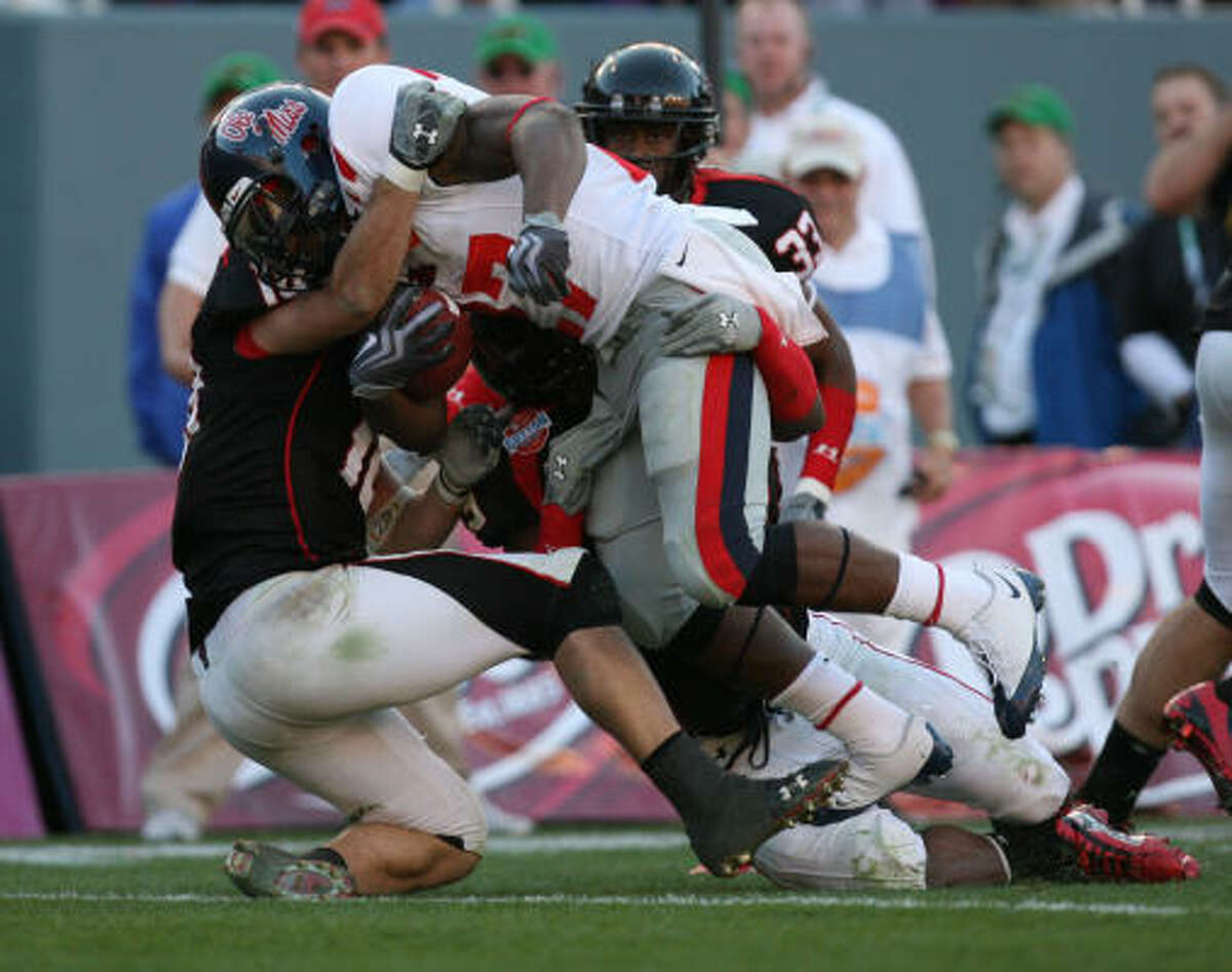 Ole Miss running back Enrique Davis is brought down by a couple of Texas Tech defenders.