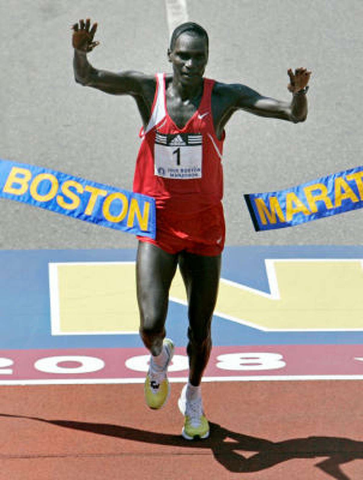 Robert Cheruiyot of Kenya raises his arms as he breaks the tape to win the Boston Marathon in Boston on Monday.