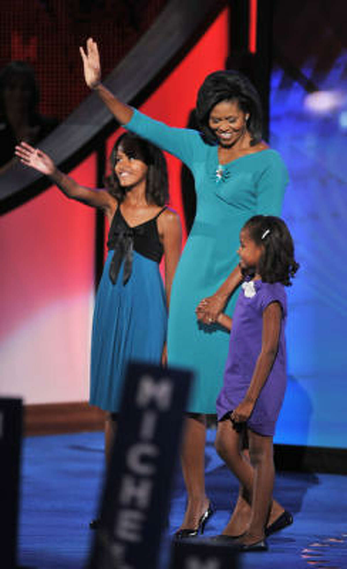 Michelle Obama, wife of US Democratic presidential candidate Barack Obama, brings daughters Malia, left, and Sasha on stage after her speech.