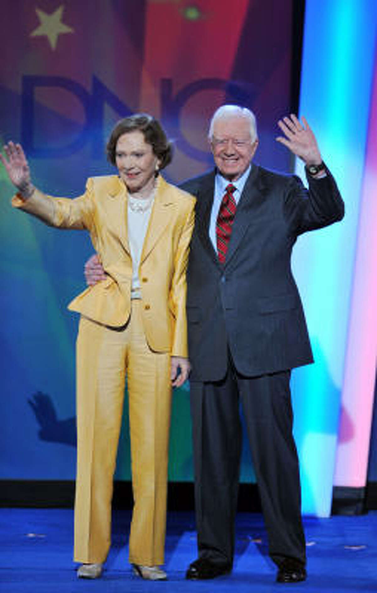 Former US president Jimmy Carter and his wife, Rosalynn, wave to supporters at the convention.