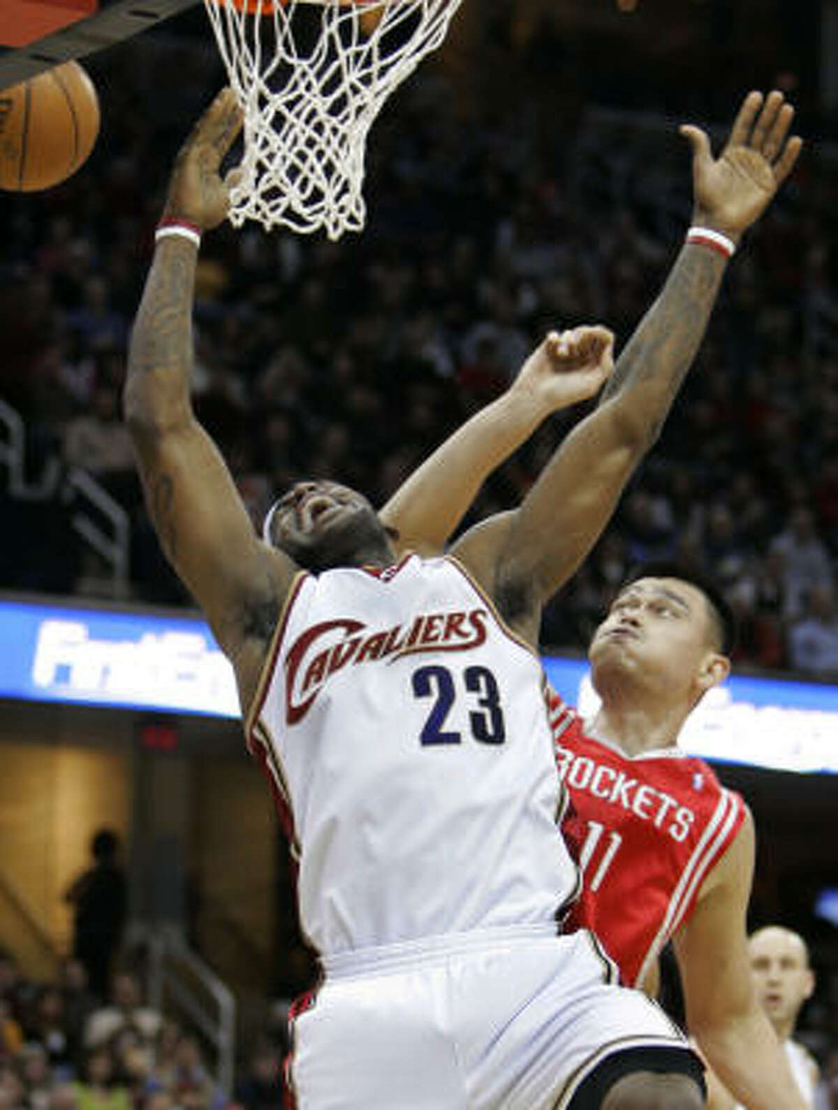 Cleveland Cavaliers forward LeBron James has the ball knocked away by Houston Rockets' Yao Ming during the first quarter.