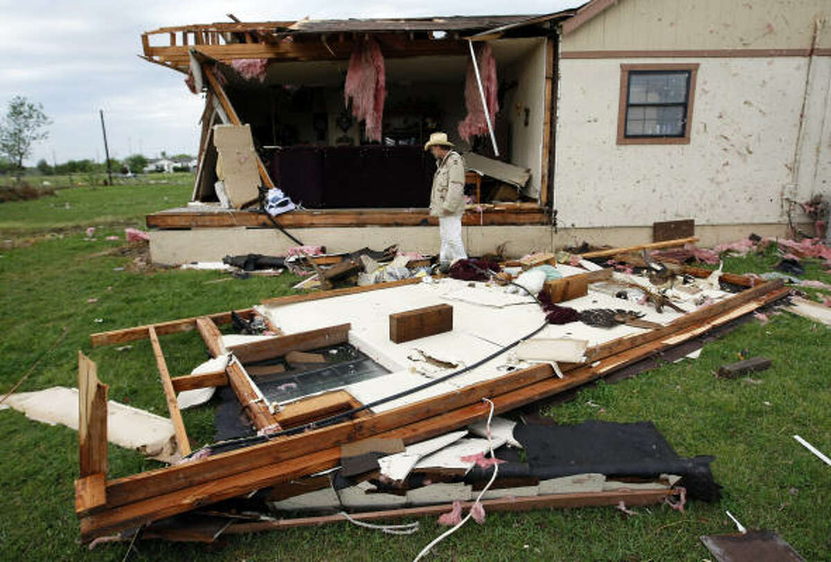 Johnson County resident Corbett "Butch" Bitner surveys the damage after an early morning storm ripped through his home near Egan, Texas, just south of Burleson today.