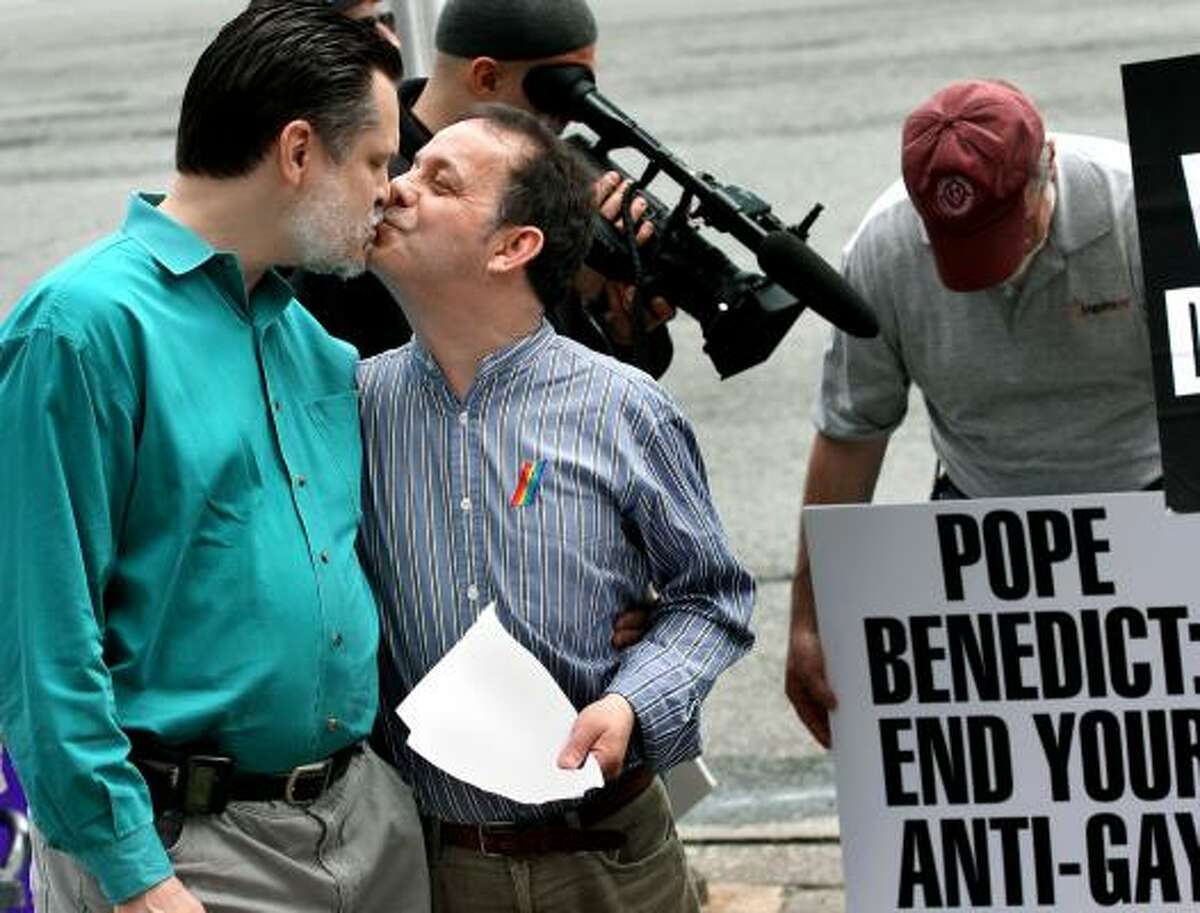 Tom Moulton, left, kisses his husband, Brendan Fay, at a demonstration for gay rights group DignityUSA in New York on Saturday. The two were legally married in Canada. Gay Catholic activists, who say Pope Benedict XVI has made hurtful statements about gays, plan to protest along the papal motorcade route in Washington on Tuesday.