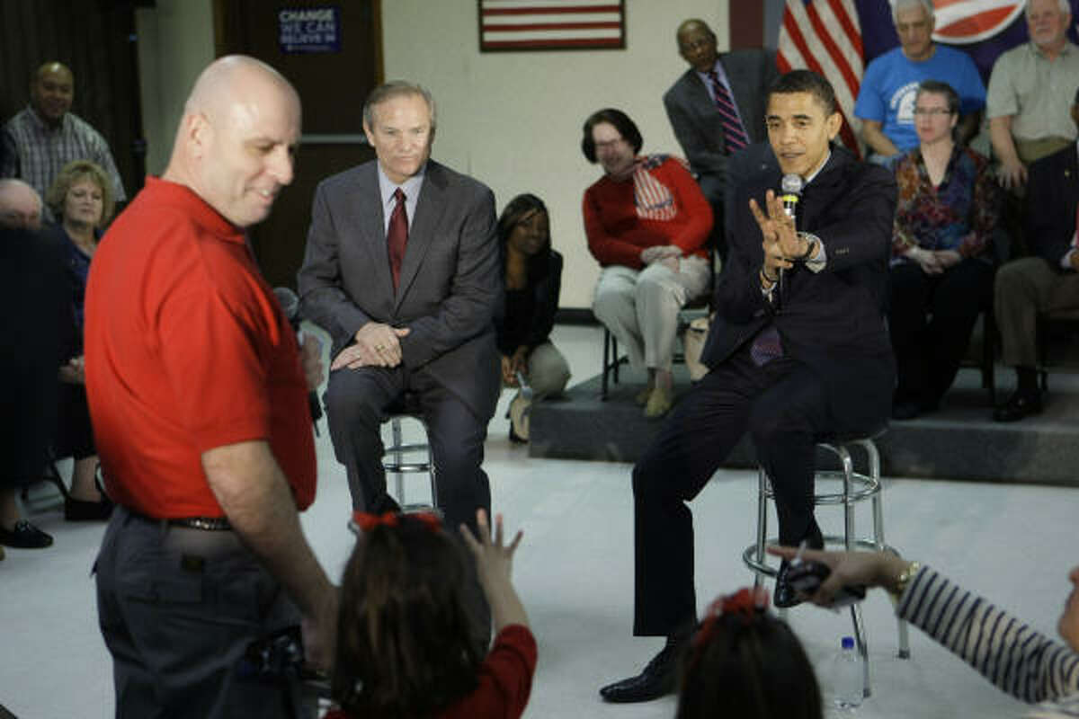Democratic presidential hopeful Sen. Barack Obama talks to John Wittershein and his family Friday as he speaks to a group of veterans and their families.