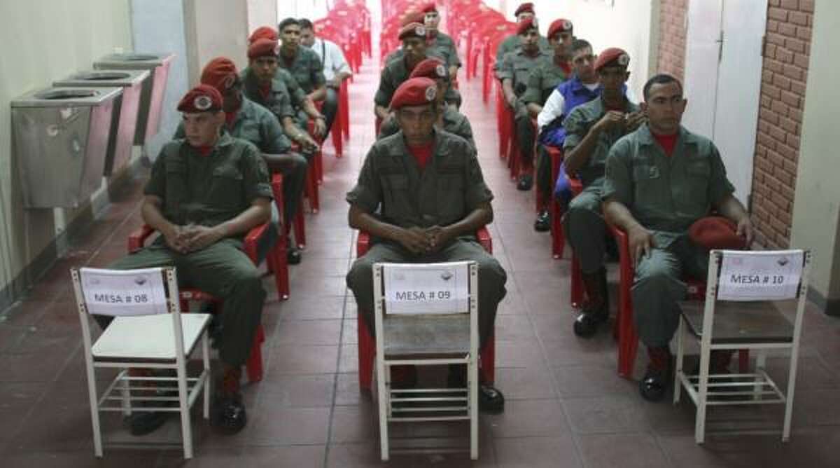 Venezuelan soldiers wait to cast their ballots last month in Caracas. Chavez helped give soldiers the right to vote.