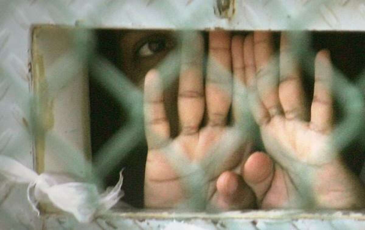 Thursday's Supreme Court ruling covers some 270 Guantanamo Bay detainees, like this one photographed in December 2006 through an opening in his cell door where food is passed through.