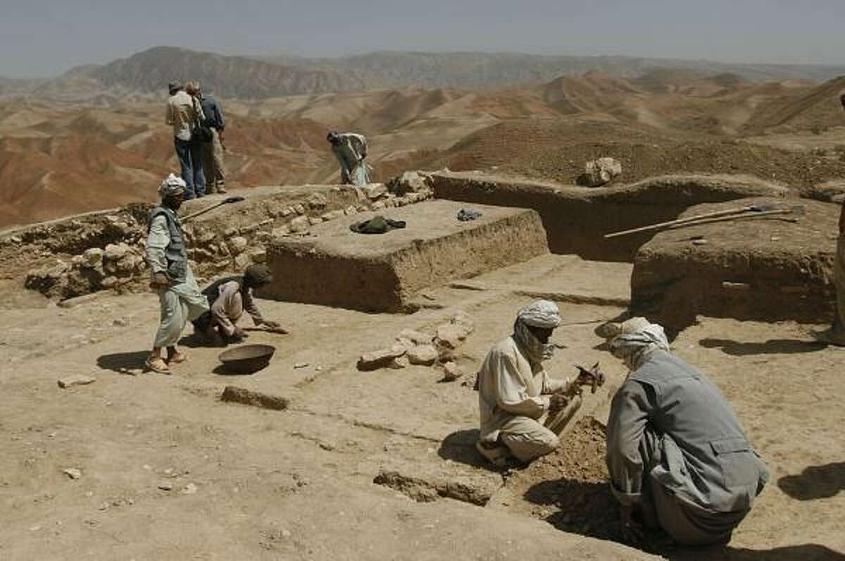 Afghan workers dig on the heights of the historically strategic region of Cheshm-e-Shafa. Some wonder if the "City of Infidels" name dates to Alexander the Great's occupation.