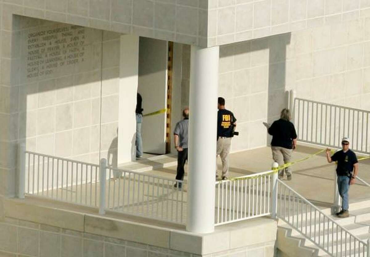 An FBI agent and another law enforcement official walk into the temple at the Yearning for Zion Ranch, home of the Fundamentalist Church of Jesus Christ of Latter Day Saints, on Tuesday in Eldorado.
