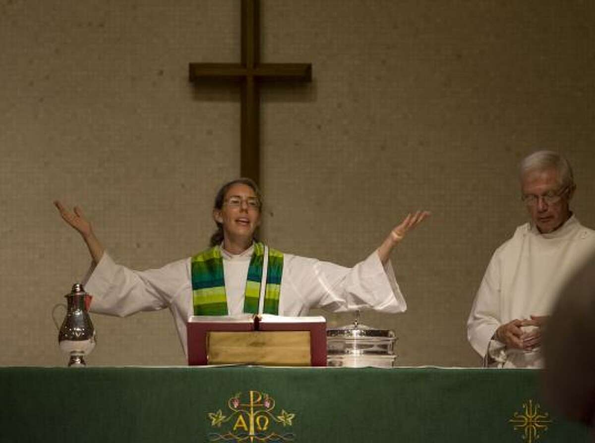 The Rev. Lura Groen is assisted by Ed Jossens during a Sunday service at Grace Evangelical Lutheran Church.