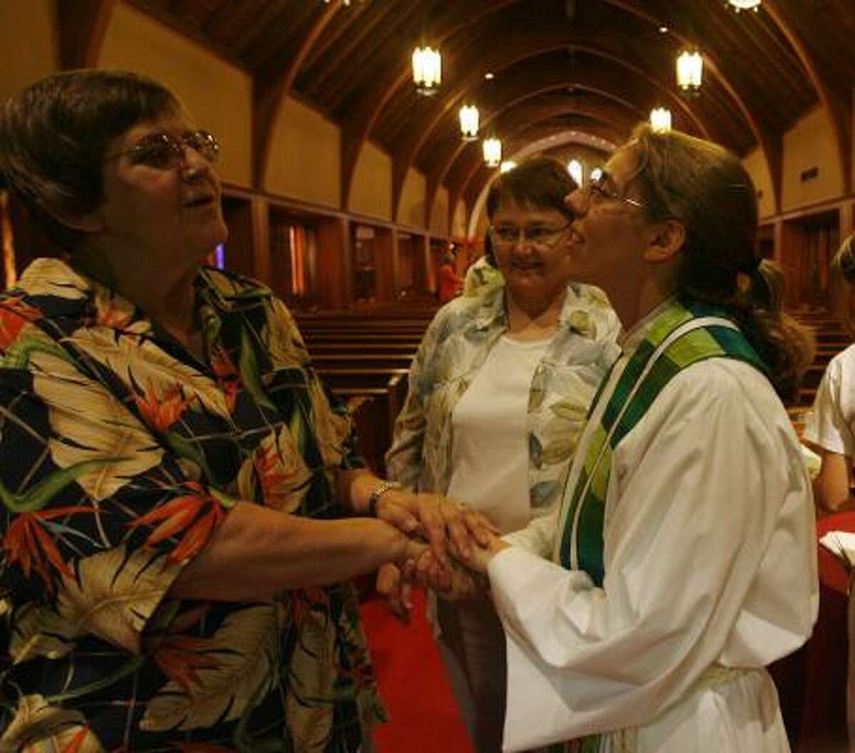 Grace Evangelical Lutheran Church's Groen chats with Peggy Cunningham, left, and Barbara Laska after a Sunday service.