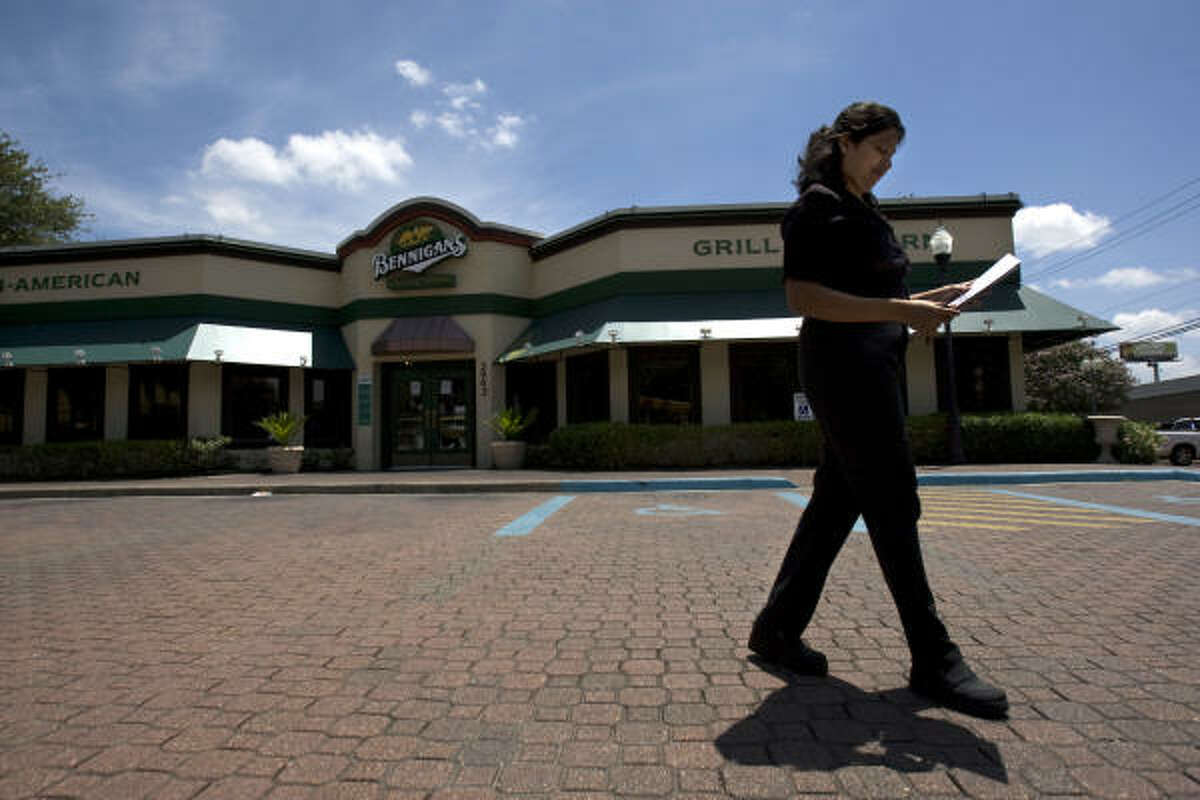 Ramey Thomas, of Houston, an occasional diner at the Bennigan's restaurant on the corner of Kirby and the Southwest Freeway, walks back through the empty parking lot to her car after seeing the location was closed today.