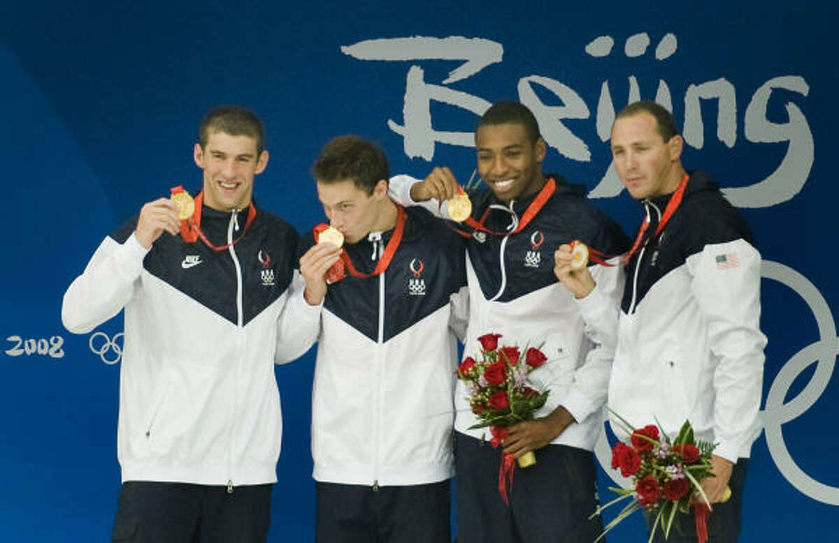 It took a world-record effort from Michael Phelps, left, and the 400 men's relay team to win gold on Monday.