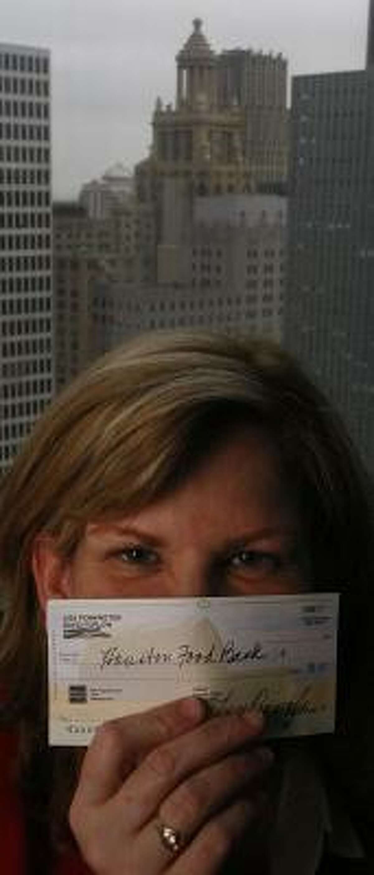 Attorney Lisa Pennington writes a check to the Houston Food Bank at the conclusion of every difficult case she tries.