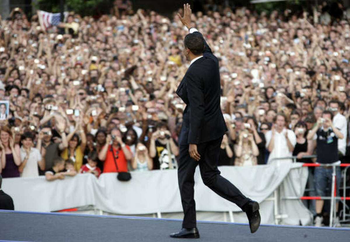 Sen. Barack Obama waves to the crowd before speaking in front of the Siegessaeule at the Grosser Stern in Tiergarten today in Berlin. According to reports, police confirmed that about 200,000 people attended the speech.