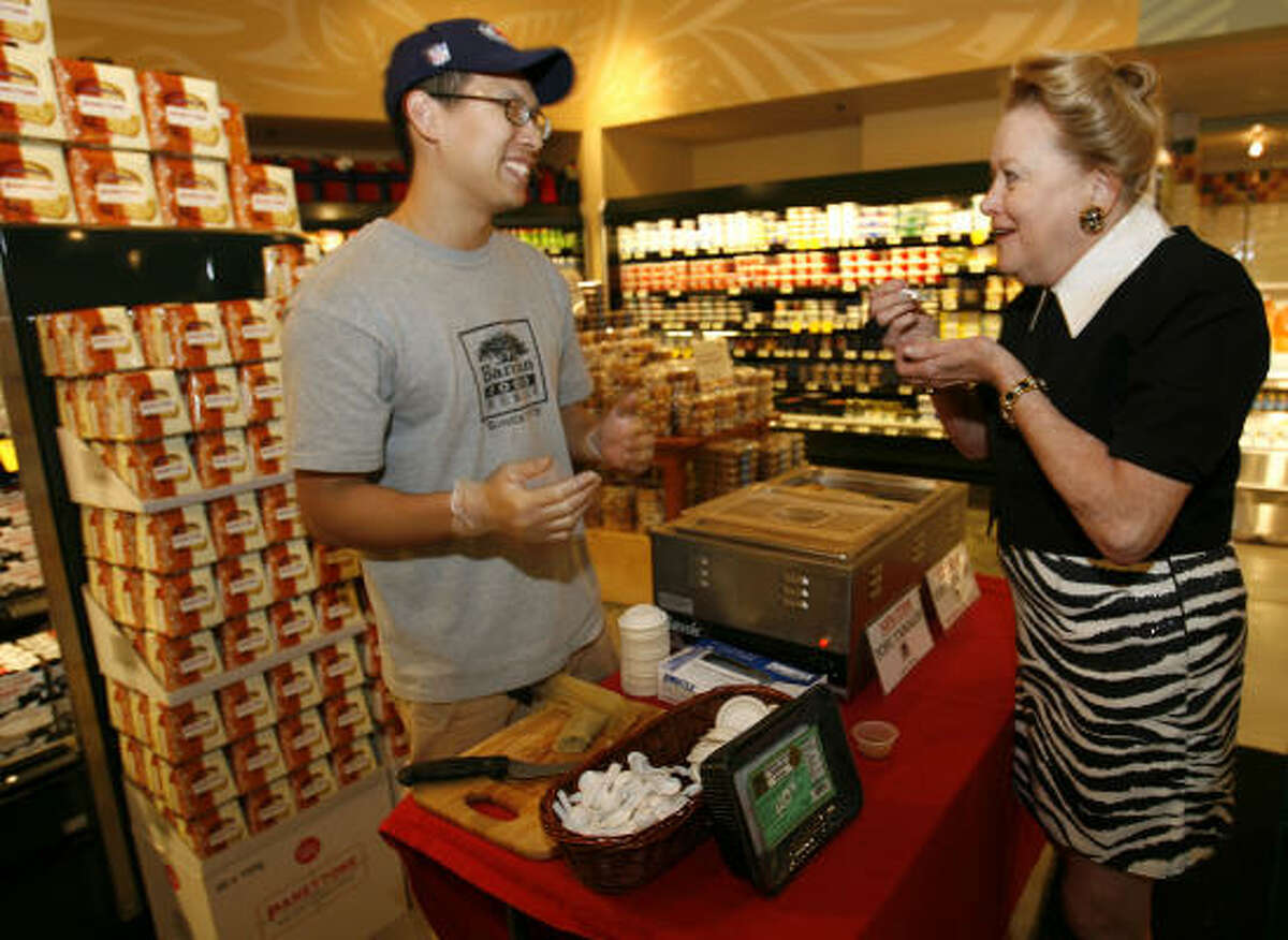 Gary Chiu of Banyan Foods hands out tofu tamale samples to Charlotte Hill and other Whole Foods shoppers this week at Kirby and Alabama.