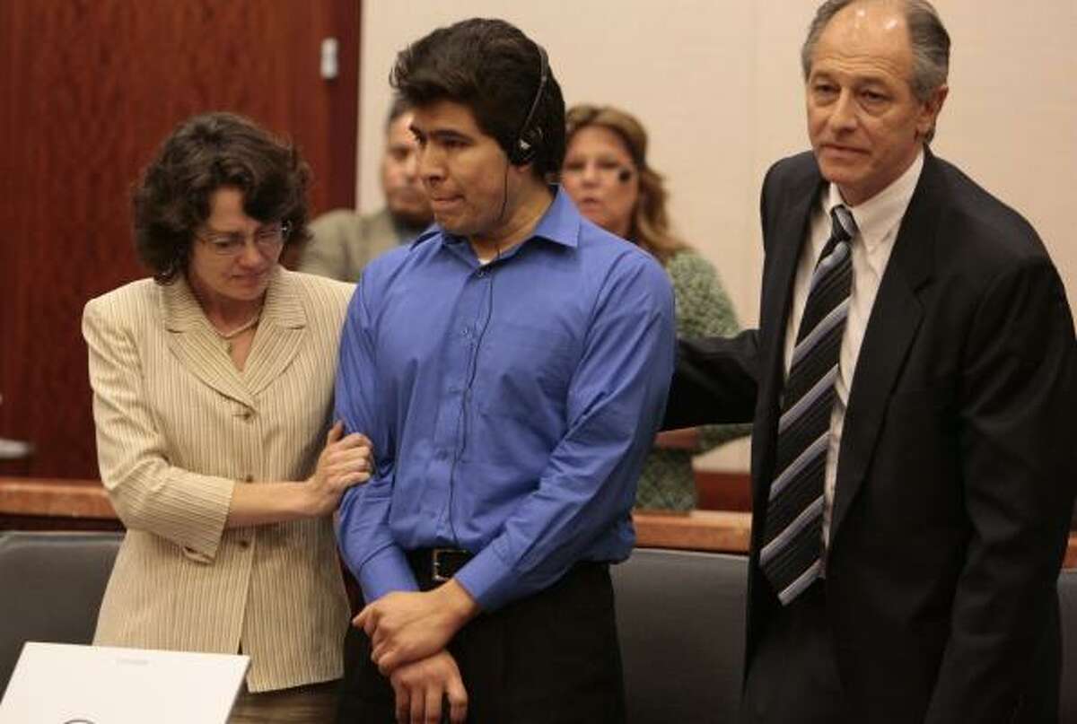 Flanked by defense attorneys Danalynn Recer and David Lane, illegal immigrant Juan Quintero listens Tuesday to a translation of his punishment for the 2006 slaying of HPD officer Rodney Johnson.