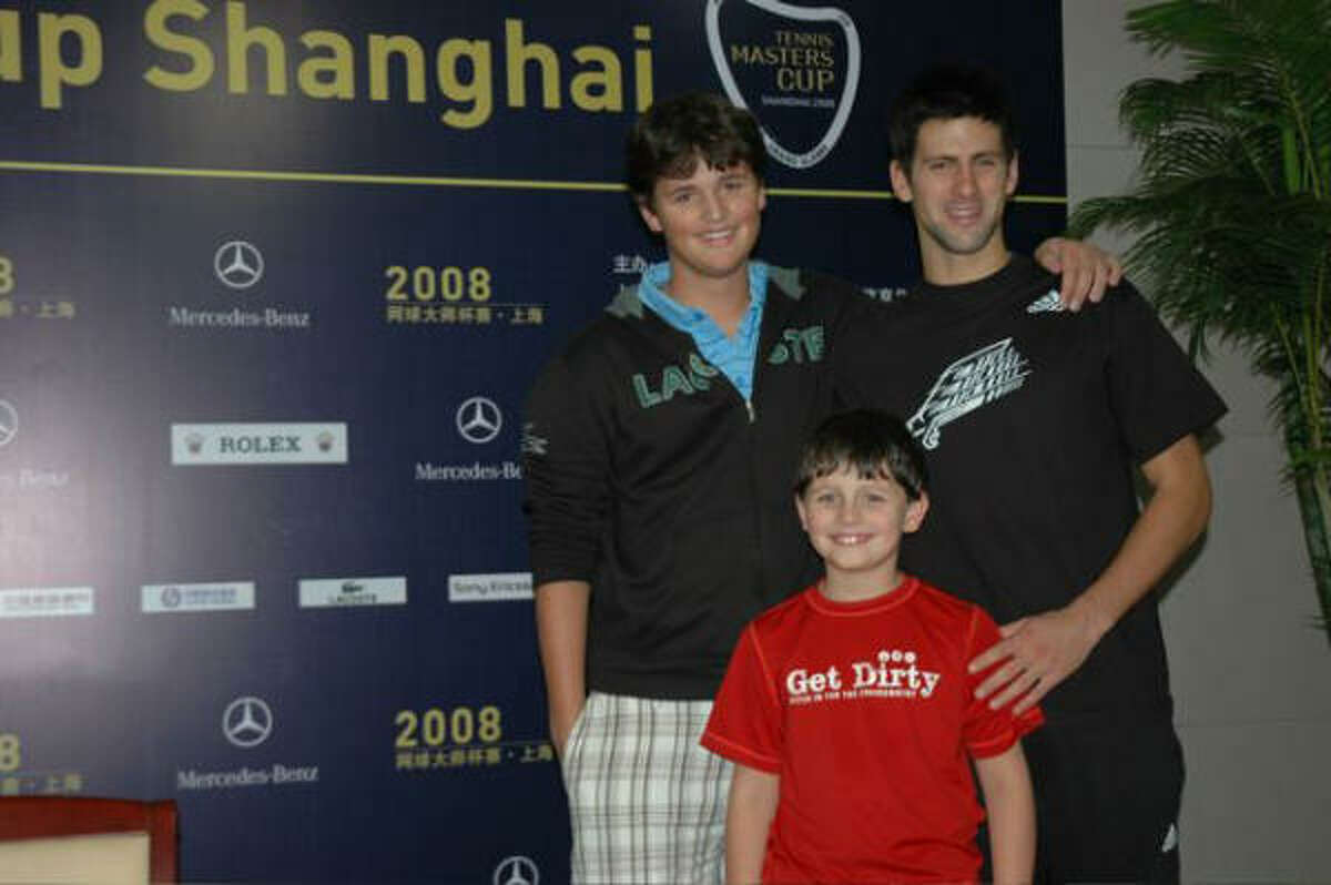 Alex Smith (left) of The Woodlands stands with Novak Djokovic (right) and little brother Jack (middle) at the Tennis Masters Cup in China.