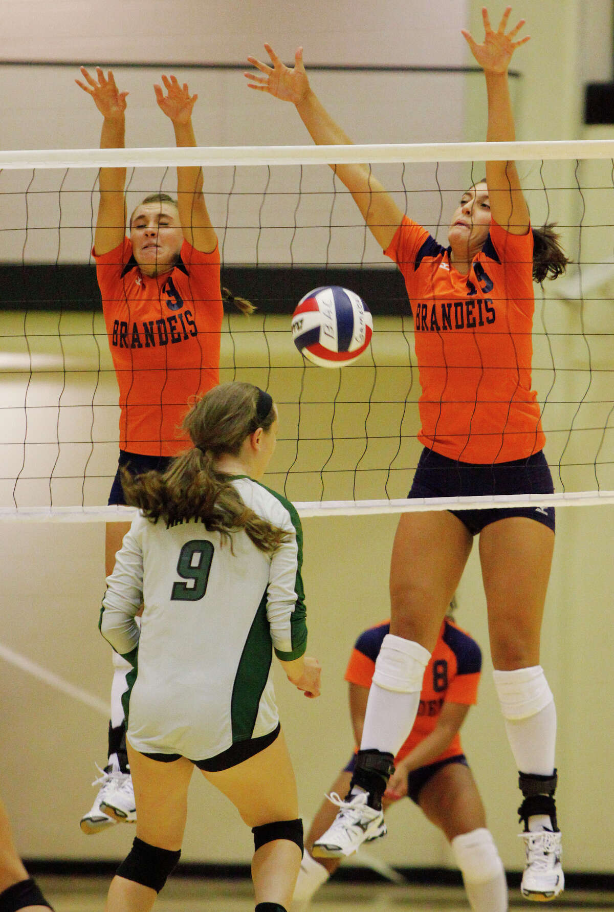 Brandeis' Marissa Banda (left) and Alex Parker defend against Reagan's Megan Kerstetter during the Rattlers' 3-1 victory over Brandeis on Monday, Aug. 8, 2011. The Broncos claimed the first game of the match, and nearly the second.