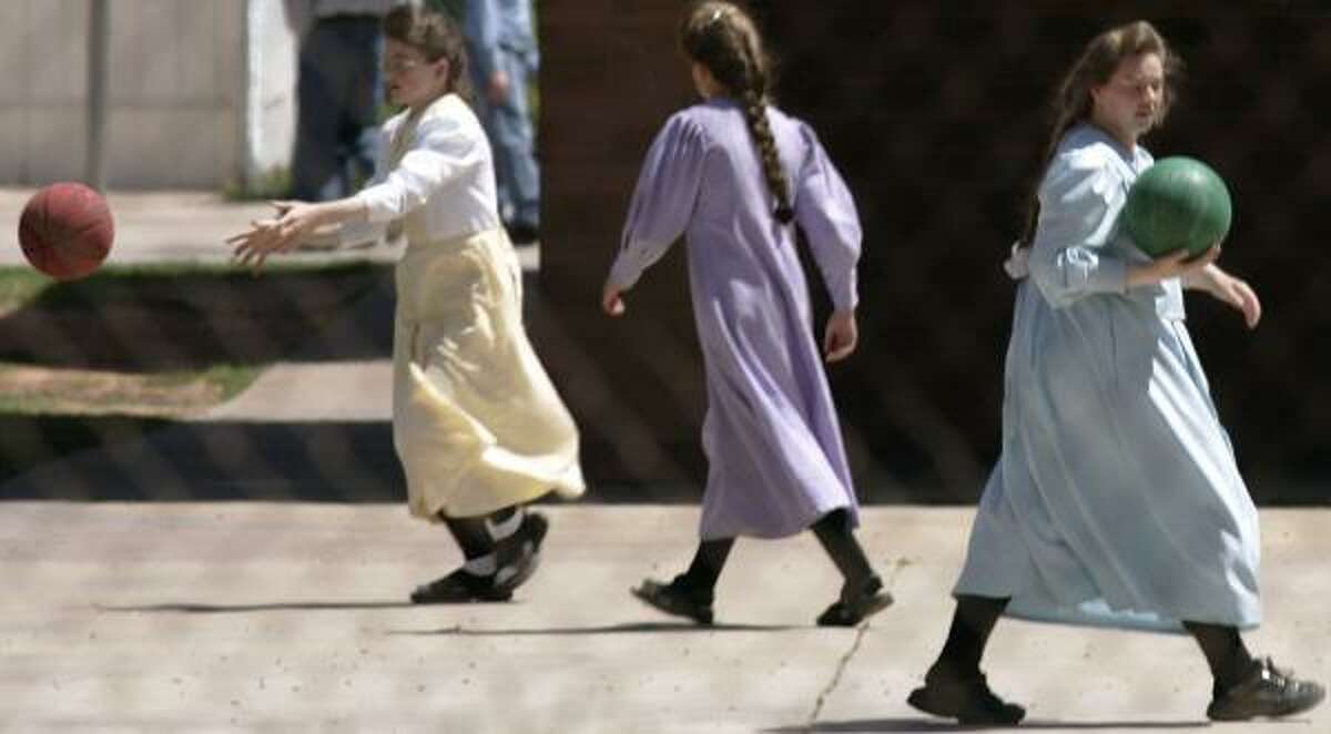 FLDS girls sport their conservative dress and play separately from the boys at a private school in Hildale, Utah, in April.
