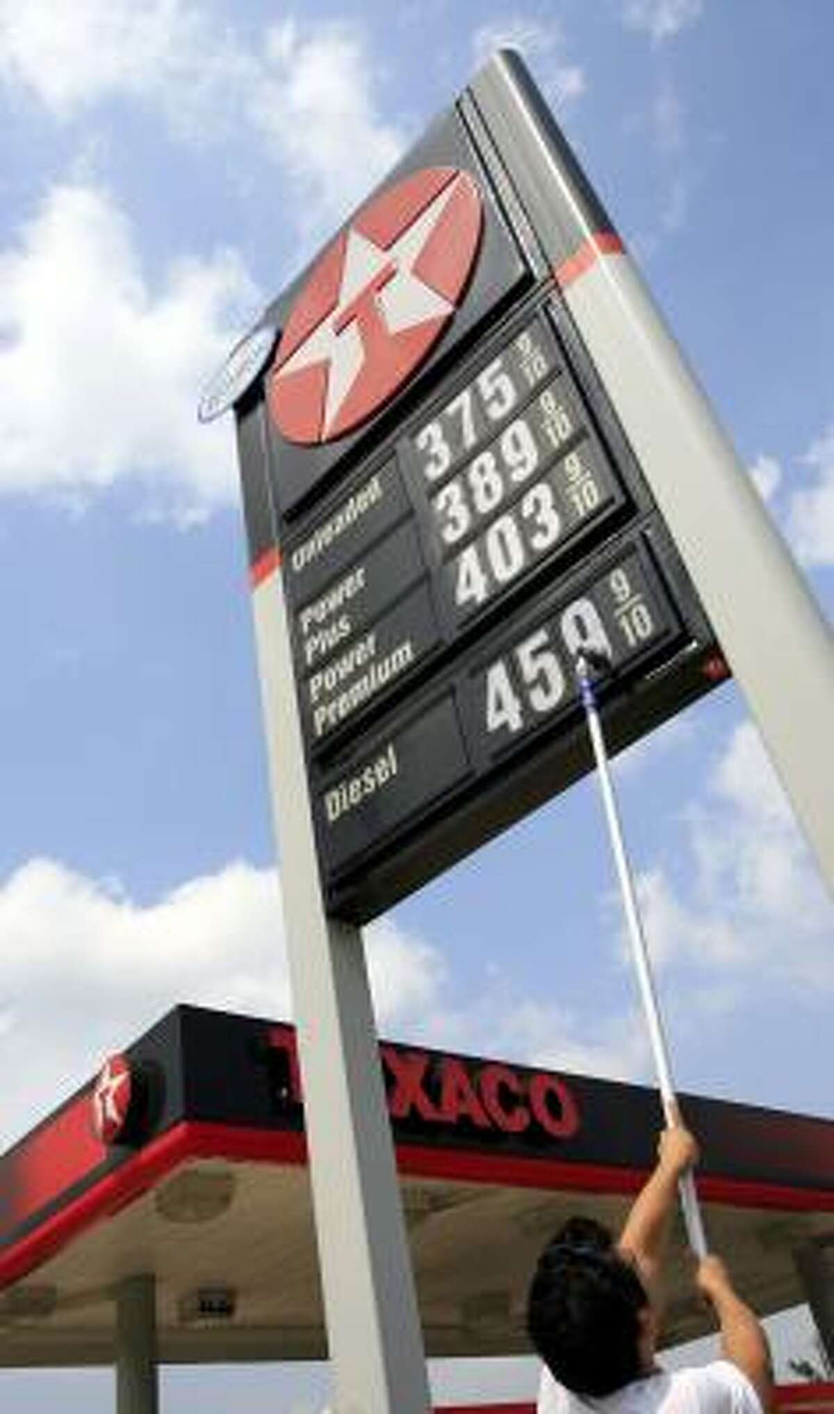 Tony Saldivar updates the price of diesel at a Houston Texaco on Thursday.