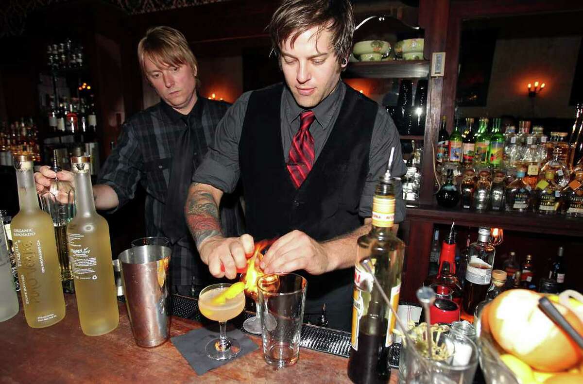 Cedar Social bartenders Craig Reeves (left) and Sonny Bonasera from Dallas prepare cocktails from a special menu during a guest apperarance last weekend at the Esquire.