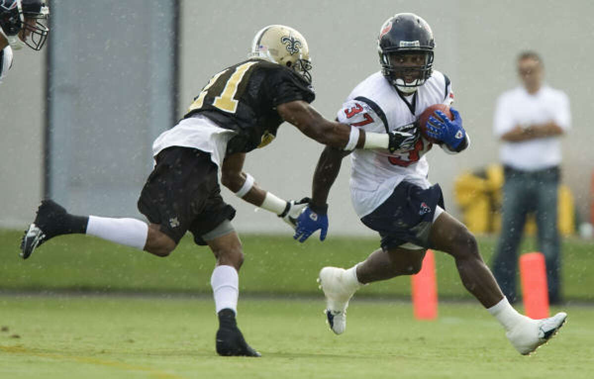 The only carries Darius Walker, right, received this year were in his practice attire and in preseason games.