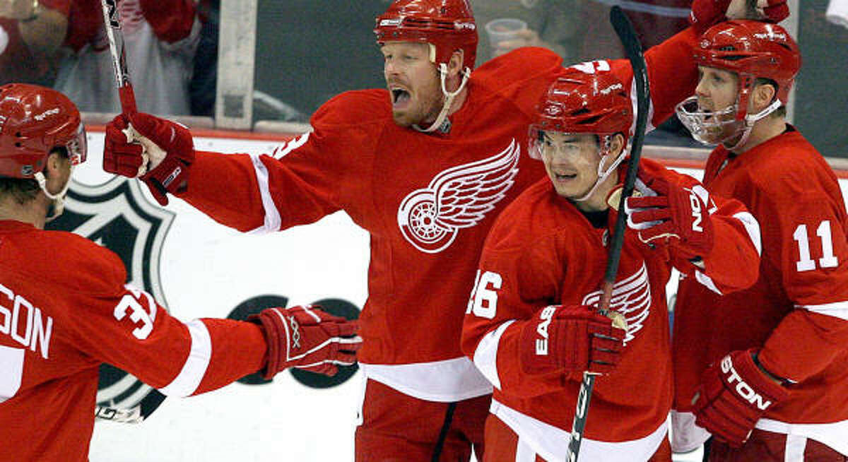 The Red Wings' Johan Franzen celebrates his first period goal with teammates against the Avalanche.