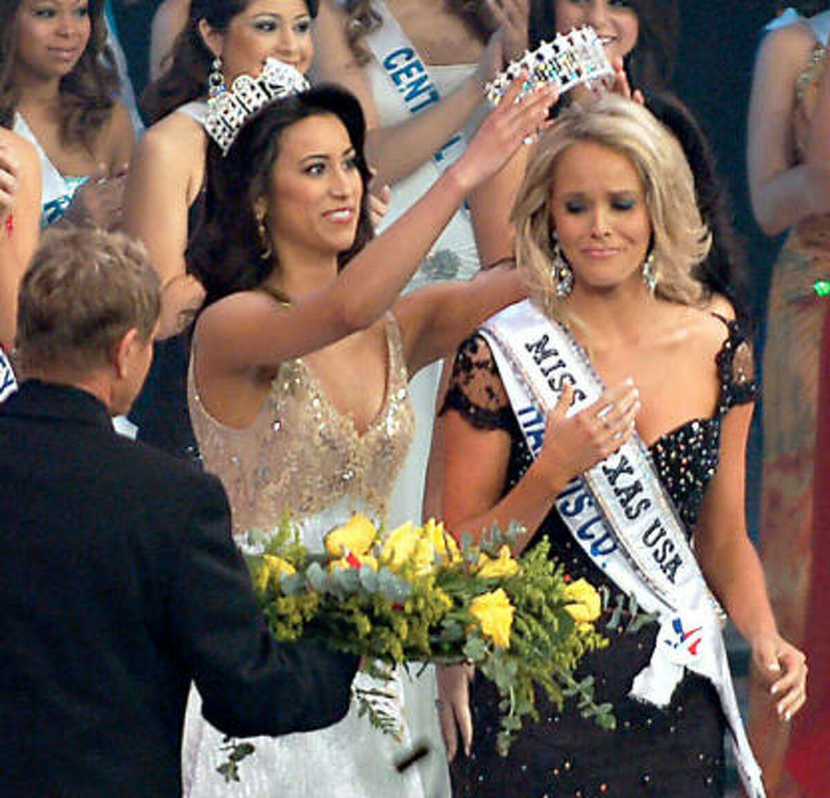 Miss Harris County, Brooke Daniels, is crowned the 2009 Miss Texas USA winner by 2008 Miss Texas Teen Lauren Guzman at the Laredo Entertainment Center on Sunday.