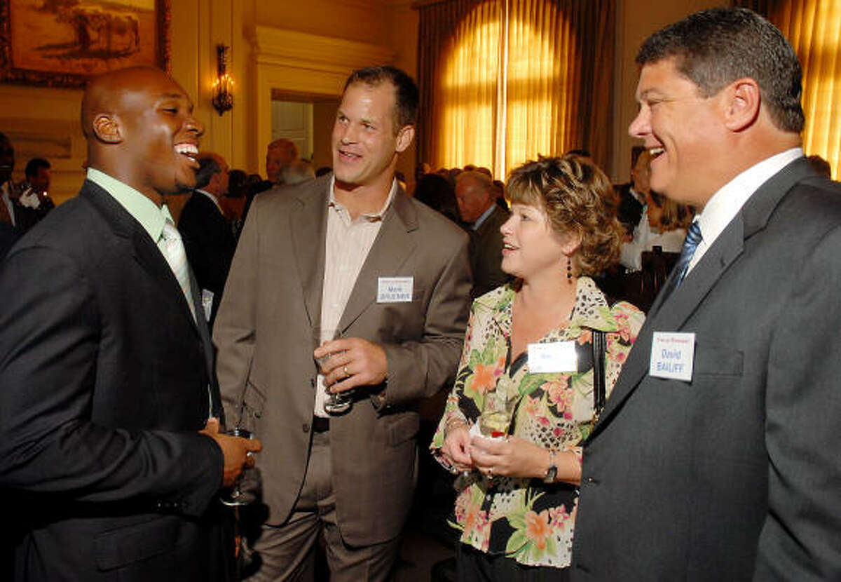 Houston Texans DeMeco Ryans, from left, and Mark Bruener talk with Angie and David Bailiff, Rice football coach, at Janice and Bob McNair's home.