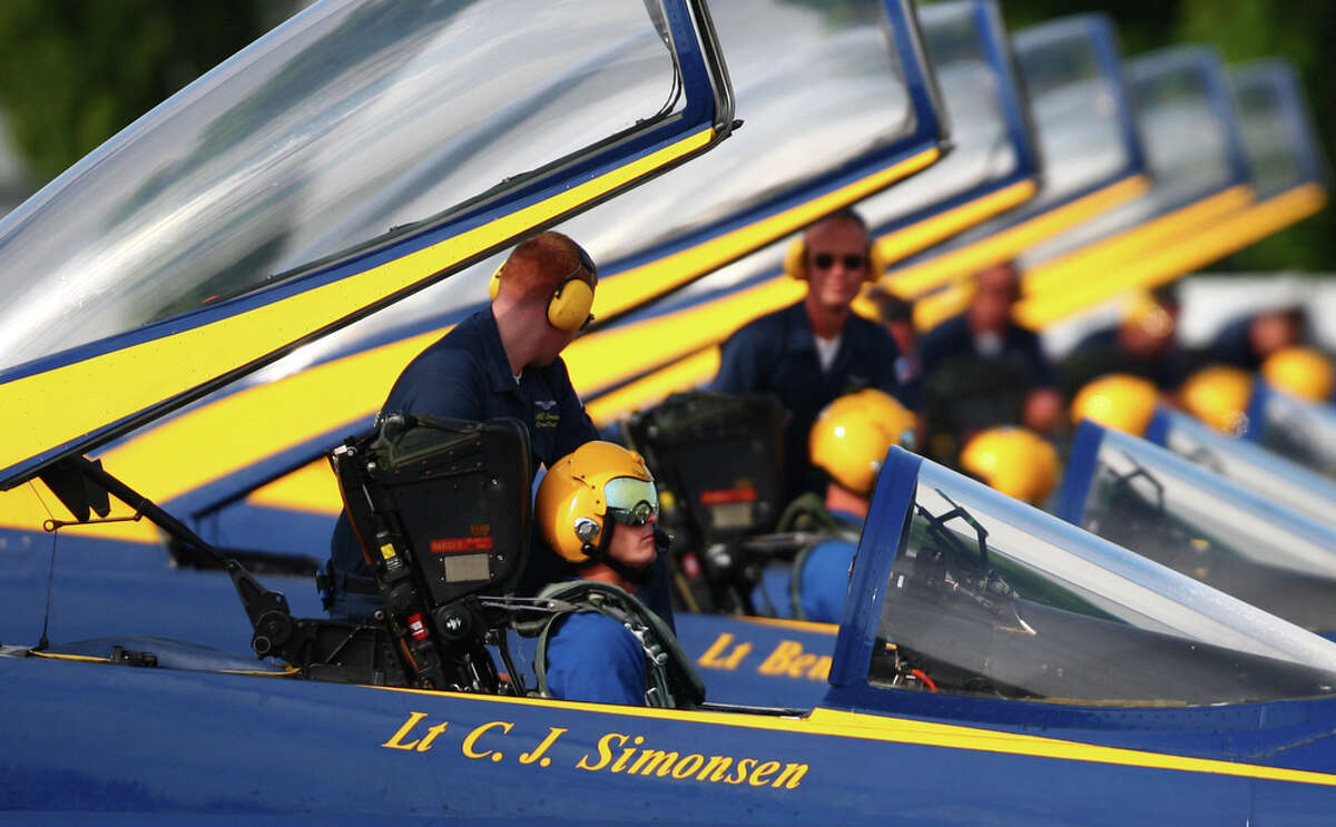 U.S. Blue Angels pilot Lt. C.J. Simonsen is readied in his F/A-18 Hornet on Tuesday, August 9, 2011 at Boeing Field in Seattle. The U.S. Navy flight demonstration team departed after their weekend performances during Seattle's annual Seafair festival.