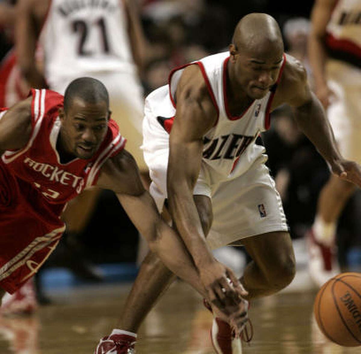 The Rockets showed a heaping helping of hustle Wednesday night, with Rockets guard Rafer Alston, left, knocking this ball away from Trail Blazers guard Jarrett Jack.