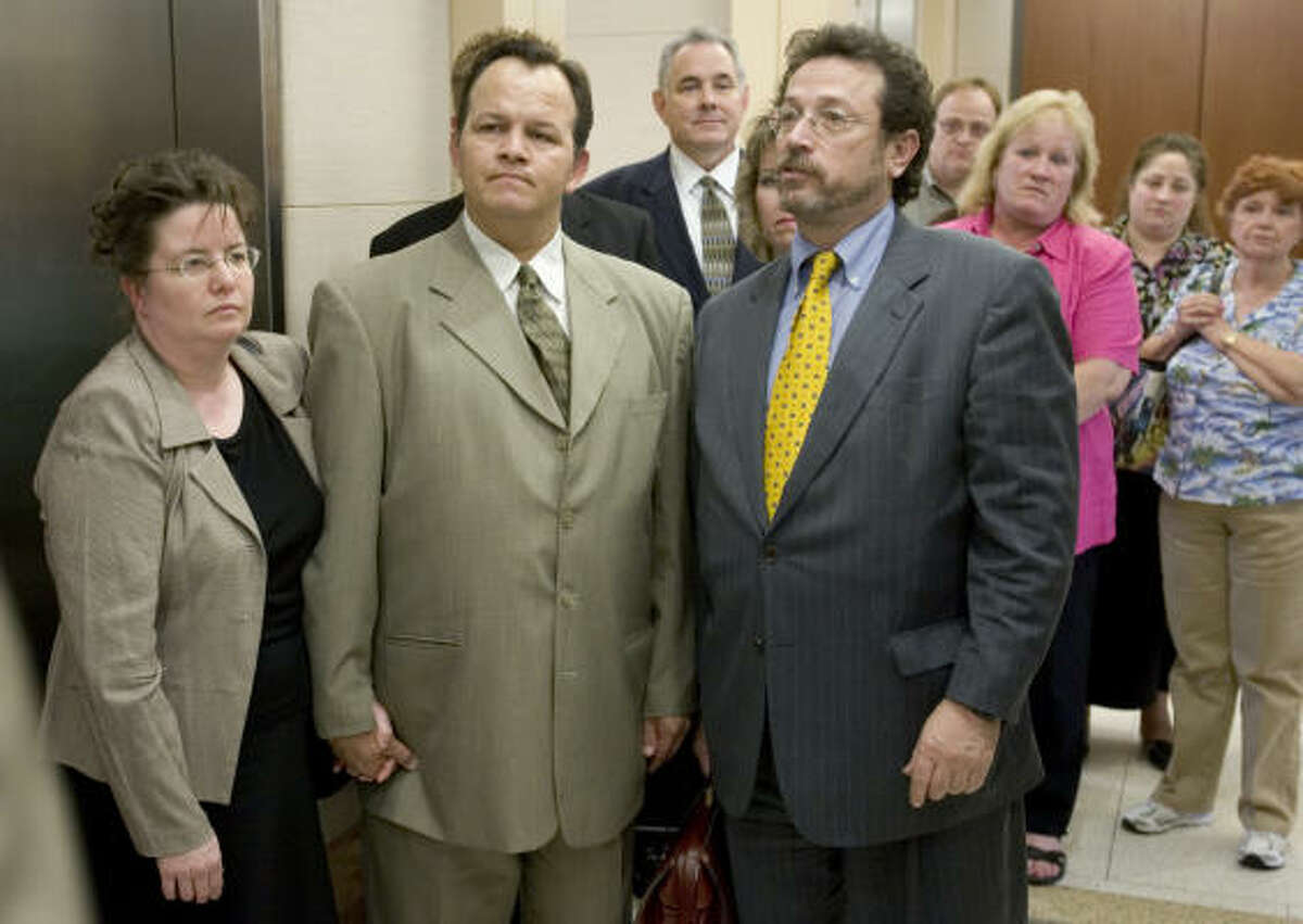 Former Pasadena school bus driver Jerry Cook, center, is flanked by his wife Annette, left, and his lawyer Robert Fickman as they leave the courthouse after Cook was found not guilty of manslaughter charges Thursday.