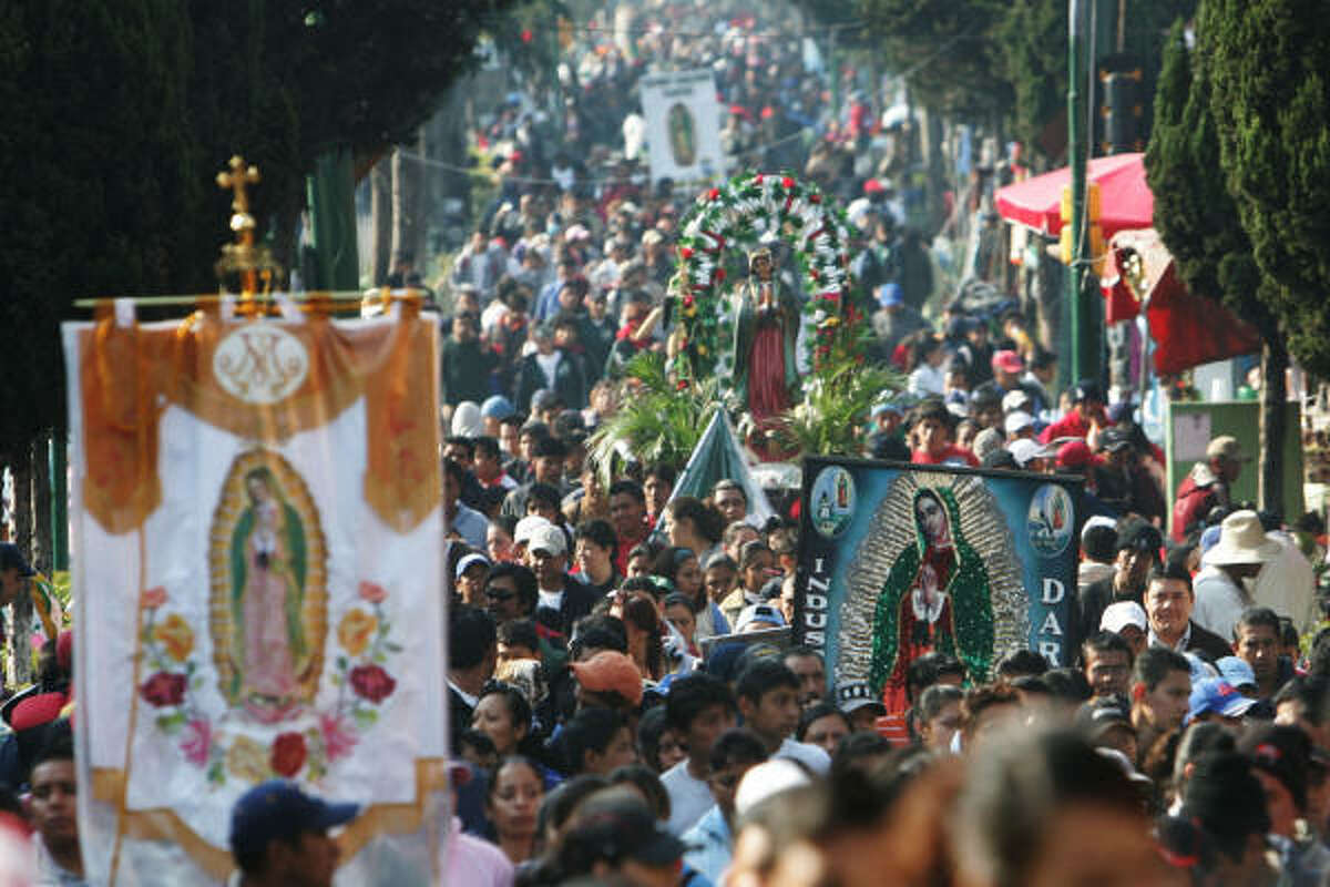 Pilgrims carry the image of the Virgin of Guadalupe to the Basilica of Guadalupe in Mexico City on Tuesday.