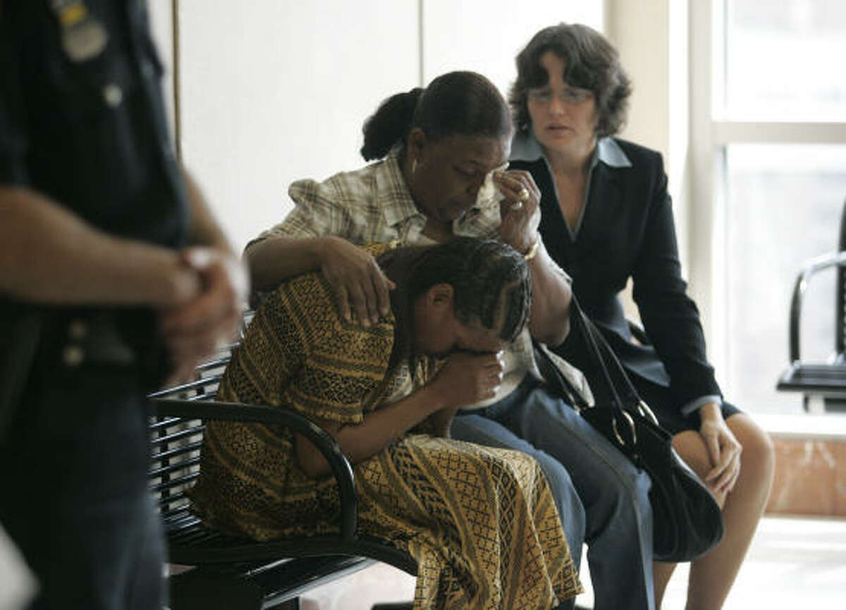 Renee Johnson, left, is comforted by a family friend, Dorothy Brooks, center, and attorney Danalynn Recer after Johnson's son, Dexter Johnson, 19, was sentenced to death Wednesday for the capital murder of Maria Aparece, 23, in the Harris County Criminal Justice Center in Houston.