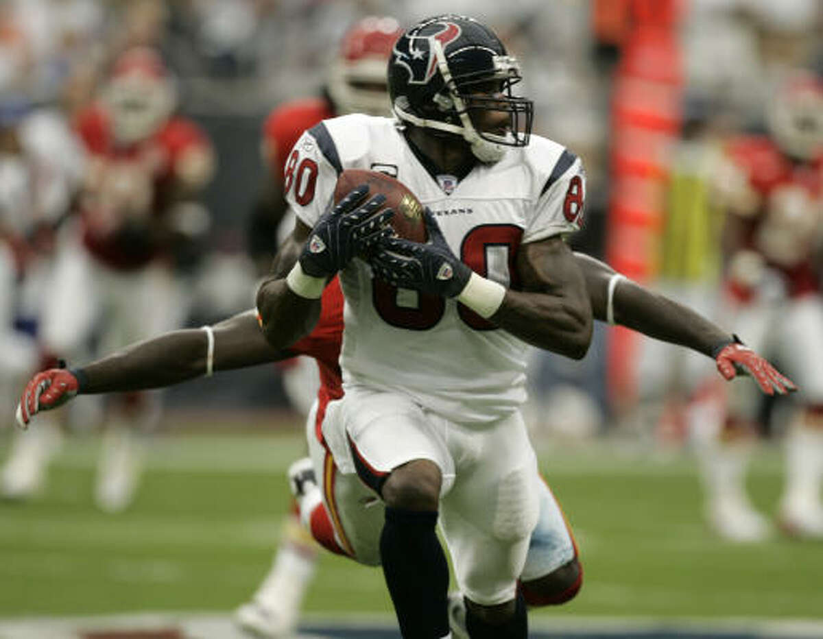 Texans wide receiver Andre Johnson (80) uses his speed to outrun a tackle attempt.