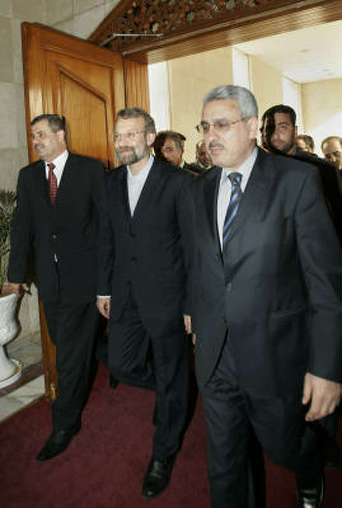 Iran's top national security official Ali Larijani, center, arrives for meeting with Iraqi Prime Minister Nouri al-Maliki in Baghdad today.