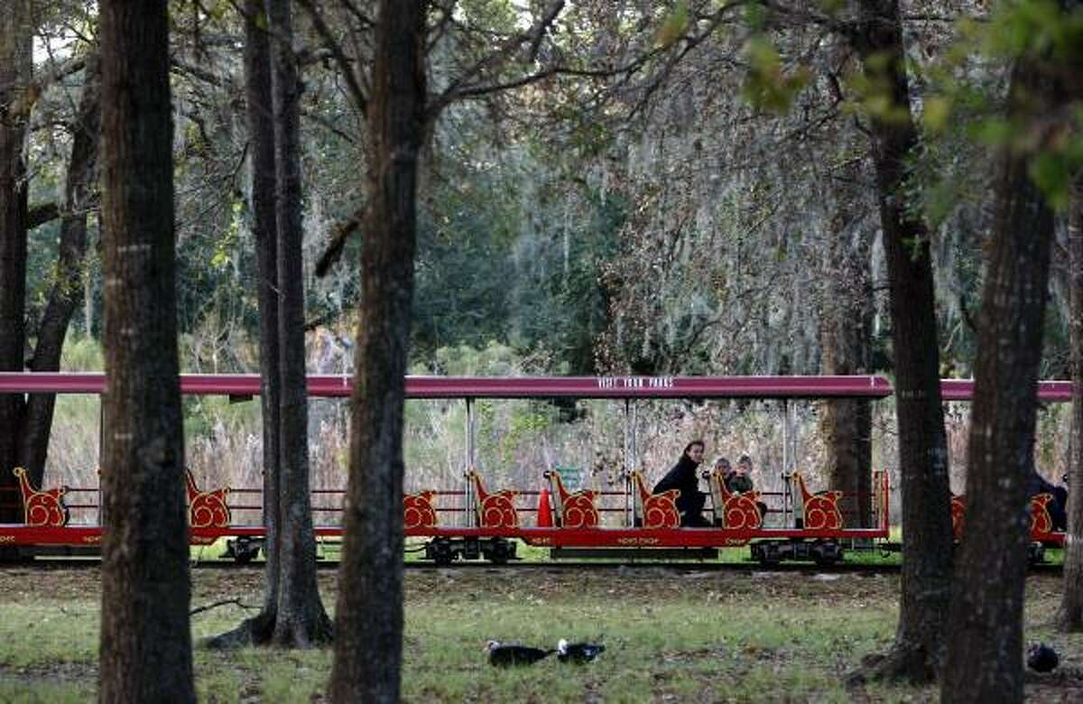 Alida Olson, son Anders, 2, and daughter Olivia, 4, ride Monday on Hermann Park's train, which makes its last stop Jan. 1. A new version opening in March will service museums and link to light rail.